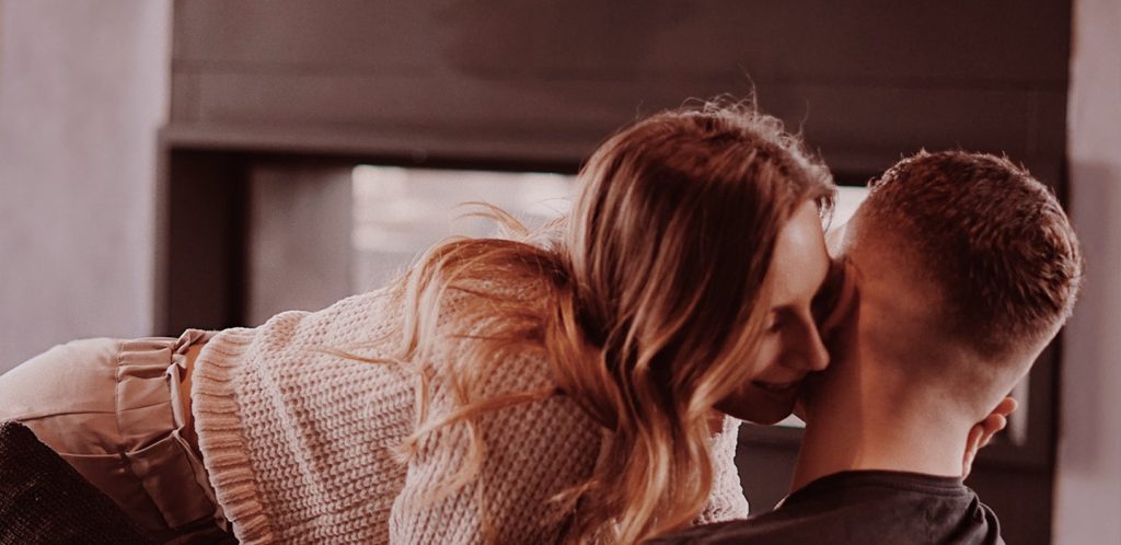 Woman whispering in partner's ear