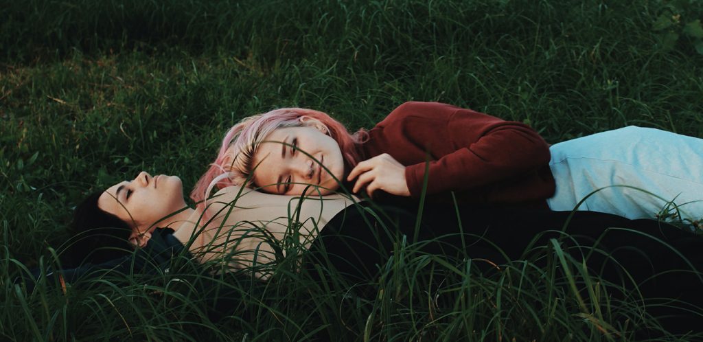 Lesbian couple friends on the grass